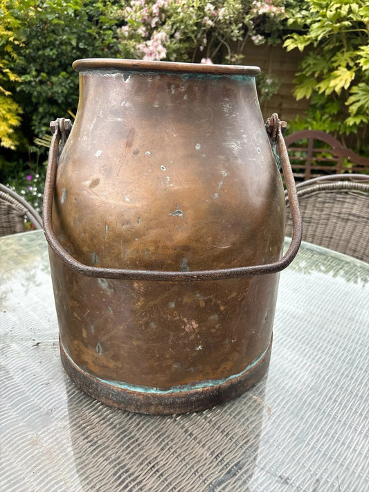 Otoch antique copper milk churn with a rustic aged patina and metal handle, ideal for rustic decor or as a planter.