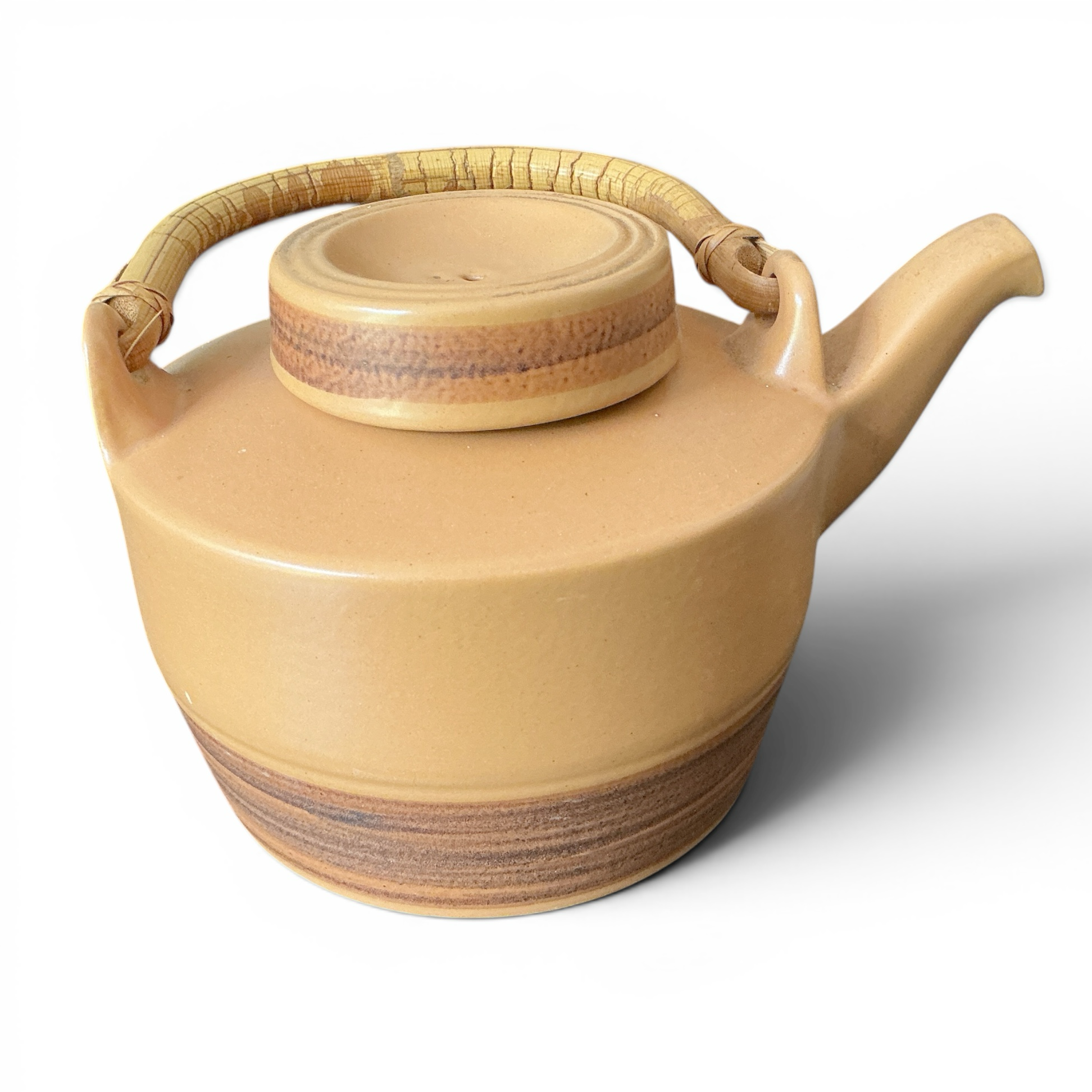 Otoch tan ceramic teapot with woven handle and lid, featuring horizontal bands and a ribbed lid.