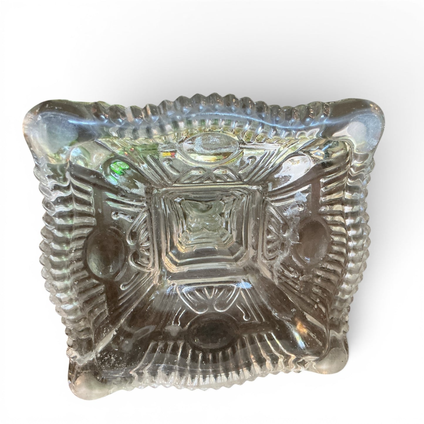 Otoch clear pressed glass candlestick holder with an ornate square base and intricate vintage-inspired detailing.