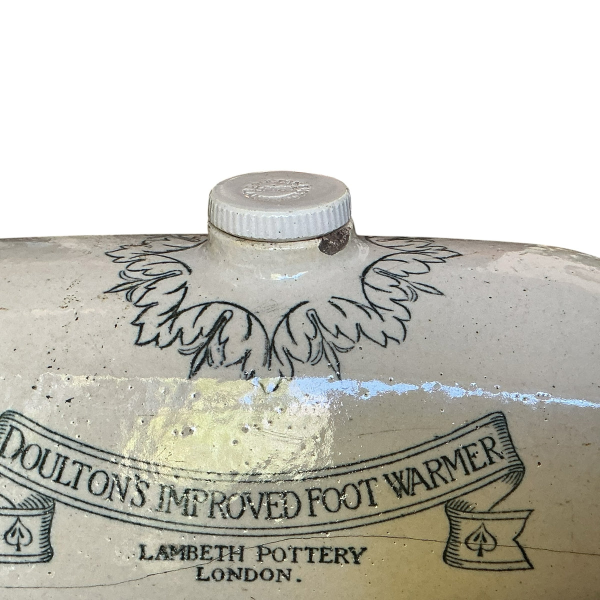 Otoch antique Doulton Lambeth cream glazed stoneware foot warmer with detailed transfer print and scrollwork.