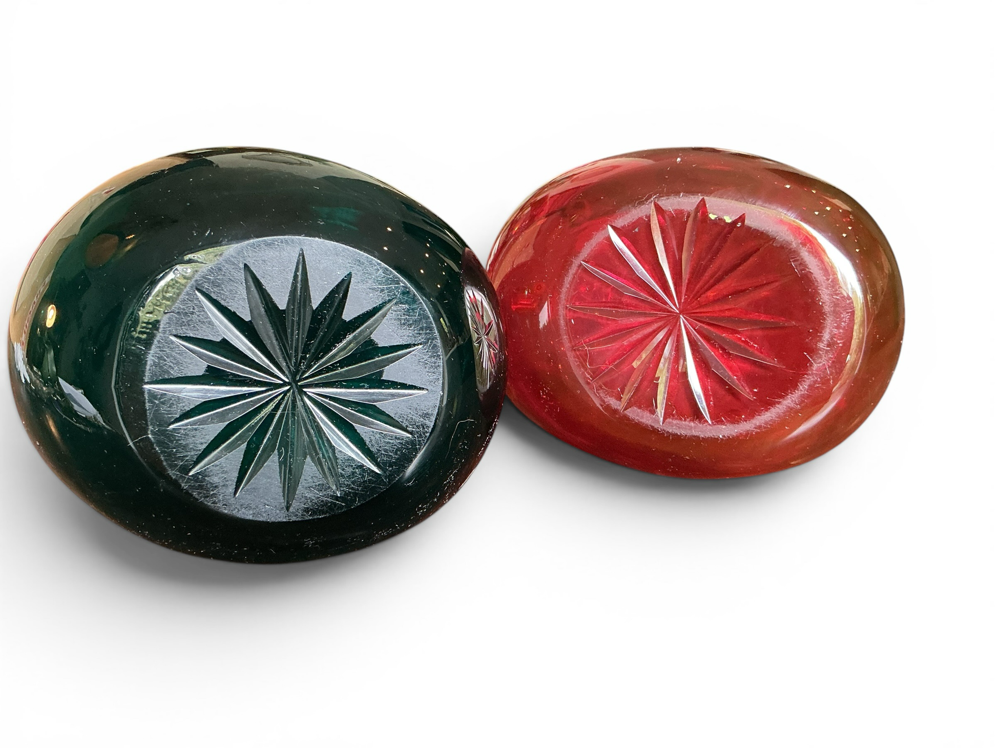 Otoch hand blown glass pitcher set bases featuring emerald green and ruby red glass with starburst cut patterns.