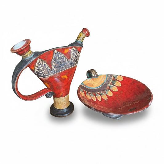 Otoch handcrafted ceramic pitcher and bowl set with vibrant red high-gloss glaze and intricate hand-carved leaf motifs.