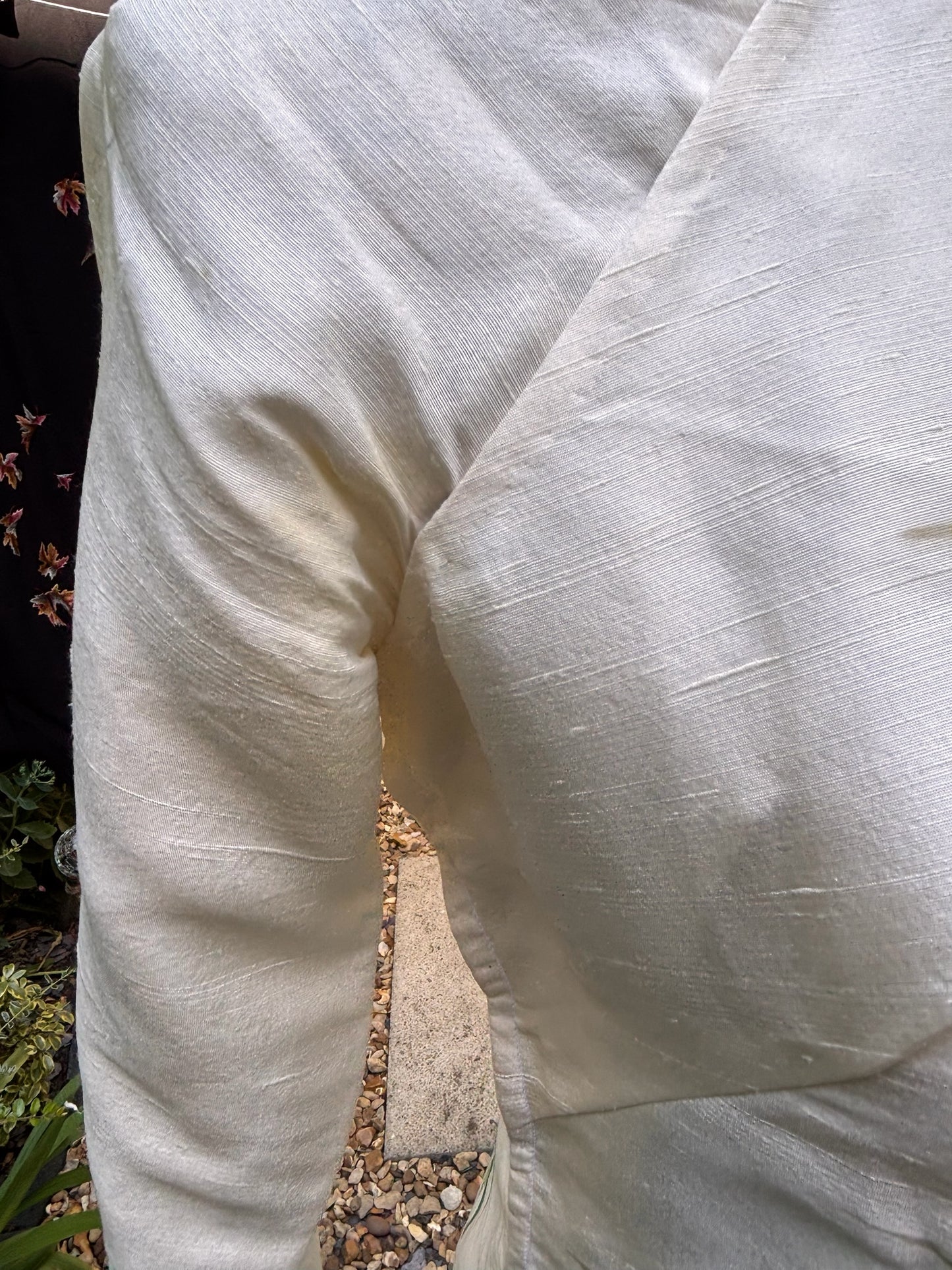 Otoch traditional Vietnamese Ao Dai in textured off-white silk-blend fabric with a subtle sheen.