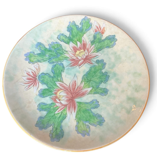 Otoch decorative porcelain wall plate featuring a hand-painted pink lotus floral motif on a mottled pastel background.
