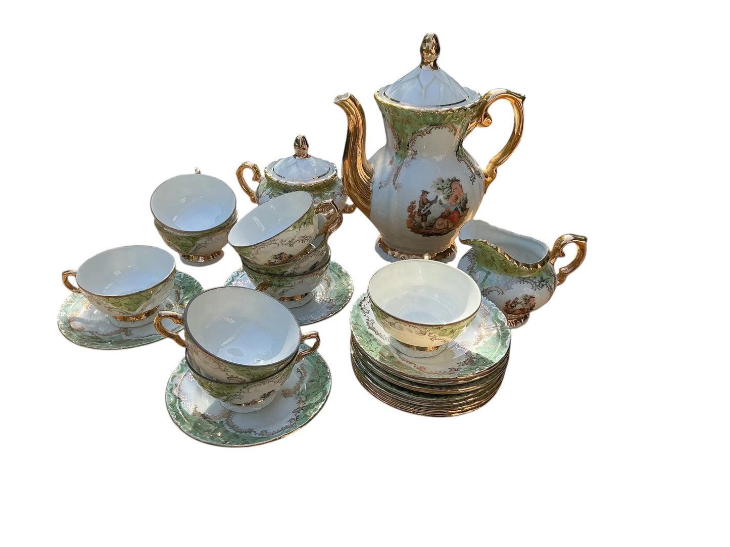 Otoch vintage porcelain tea set with gold accents, hand-painted scenes, and green trim. Includes teapot, sugar bowl, creamer, cups, and saucers.