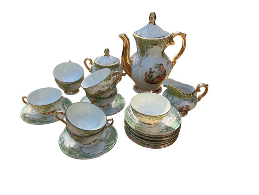 Otoch vintage porcelain tea set with gold accents, hand-painted scenes, and green trim. Includes teapot, sugar bowl, creamer, cups, and saucers.