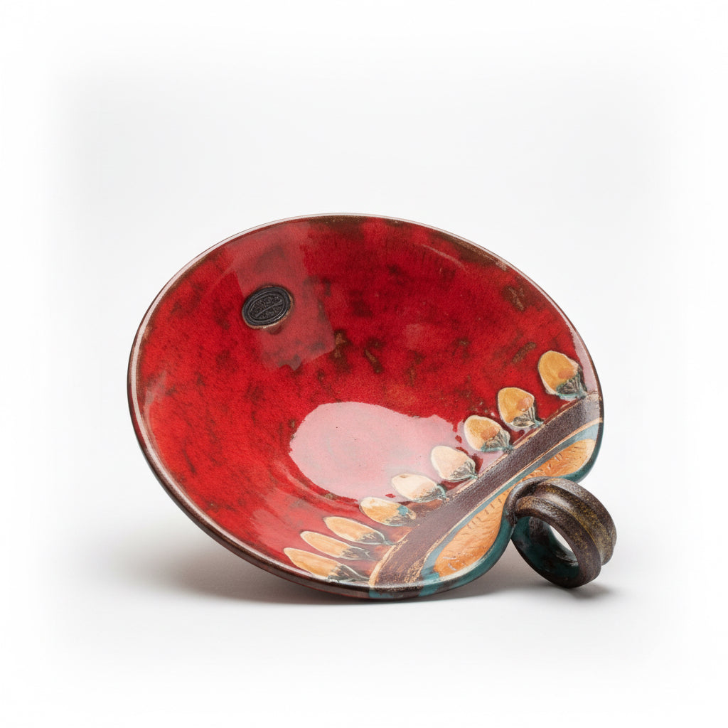 Otoch handcrafted ceramic bowl in vibrant red gloss with hand-carved leaf motifs and textured earthy accents.