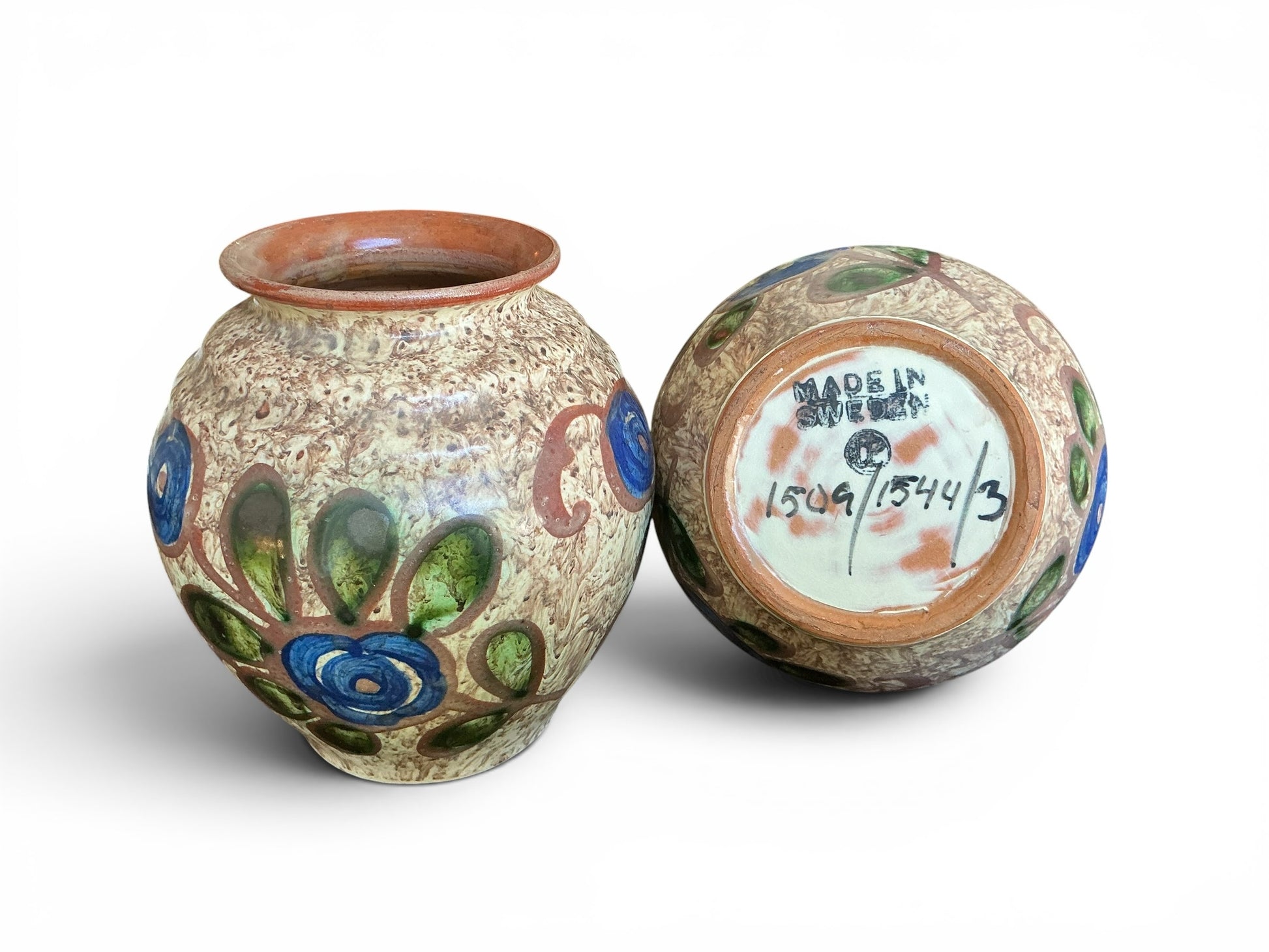 Otoch pair of vintage Swedish stoneware vases with mottled earthy glaze and hand-painted blue and green floral motifs.