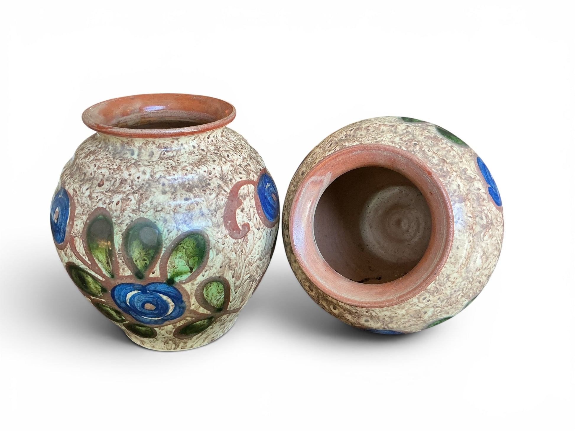 Otoch pair of handcrafted Swedish ceramic vases with mottled earthy glaze and hand-painted blue and green floral motifs.