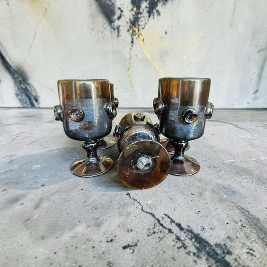 Otoch set of five vintage-inspired smoky amber glass goblets with textured raised circular detailing on stems.